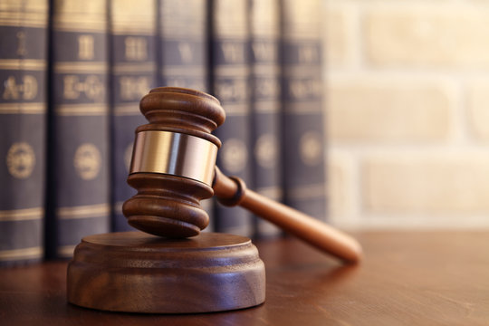 Wooden gavel with law books